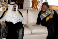 مع الرئيس الليبي السابق معمر القذافي